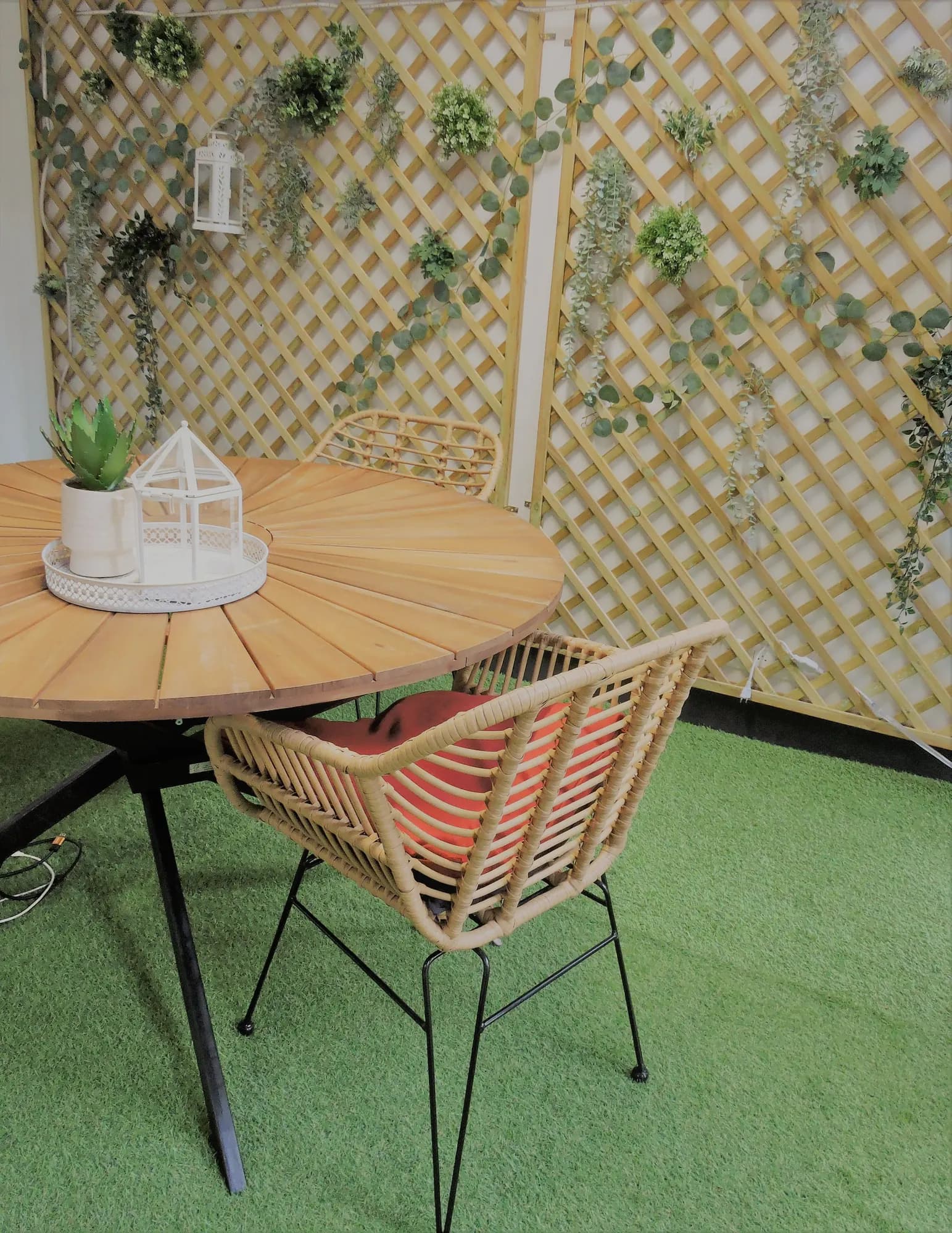 Small patio with artificial grass, a table and chairs