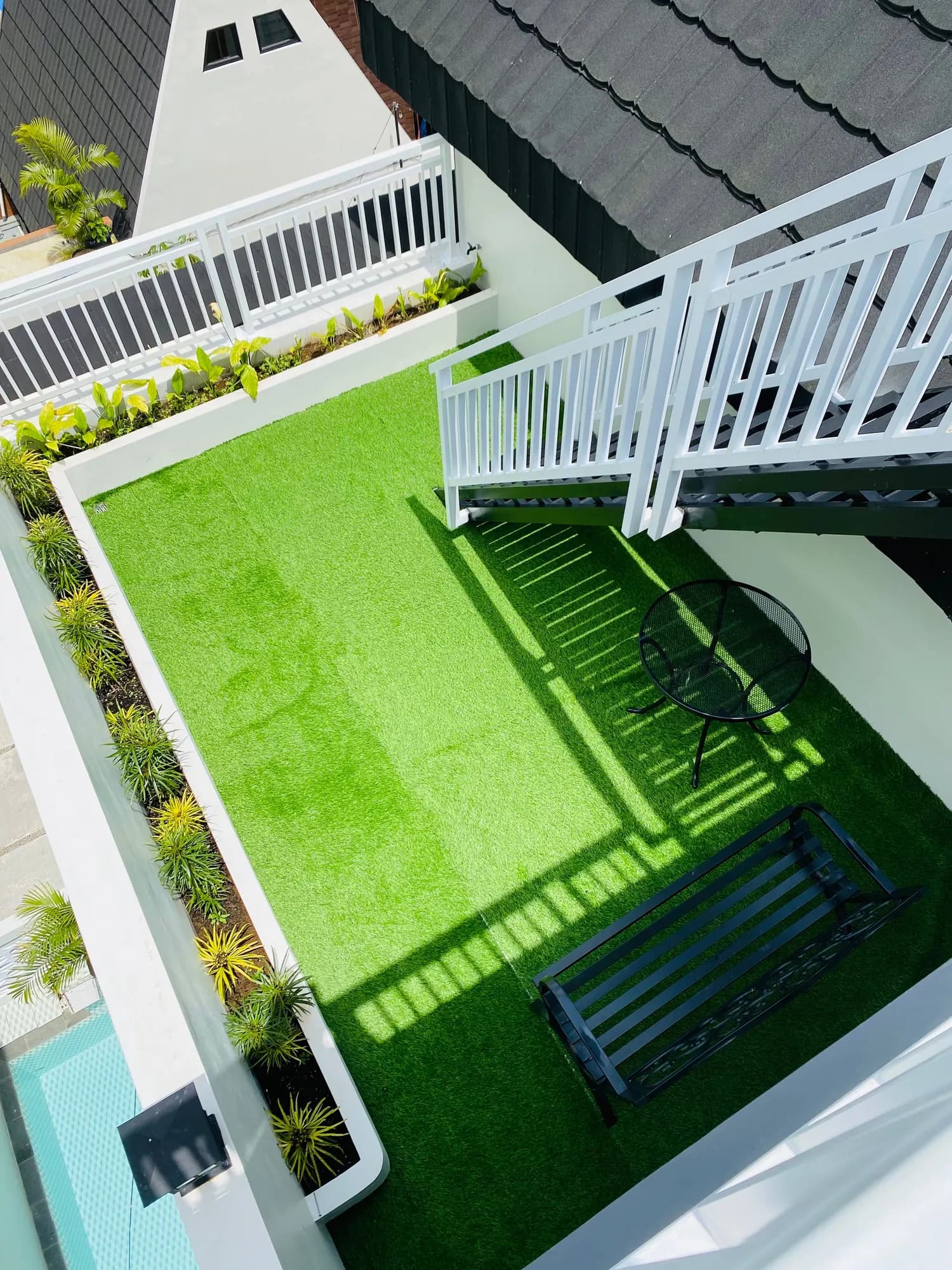 Narrow rooftop terrace with artificial grass