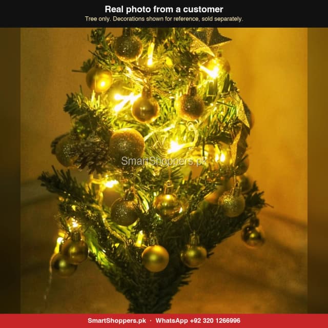 Close-up of a 2 ft Christmas tree with gold balls and fairy lights