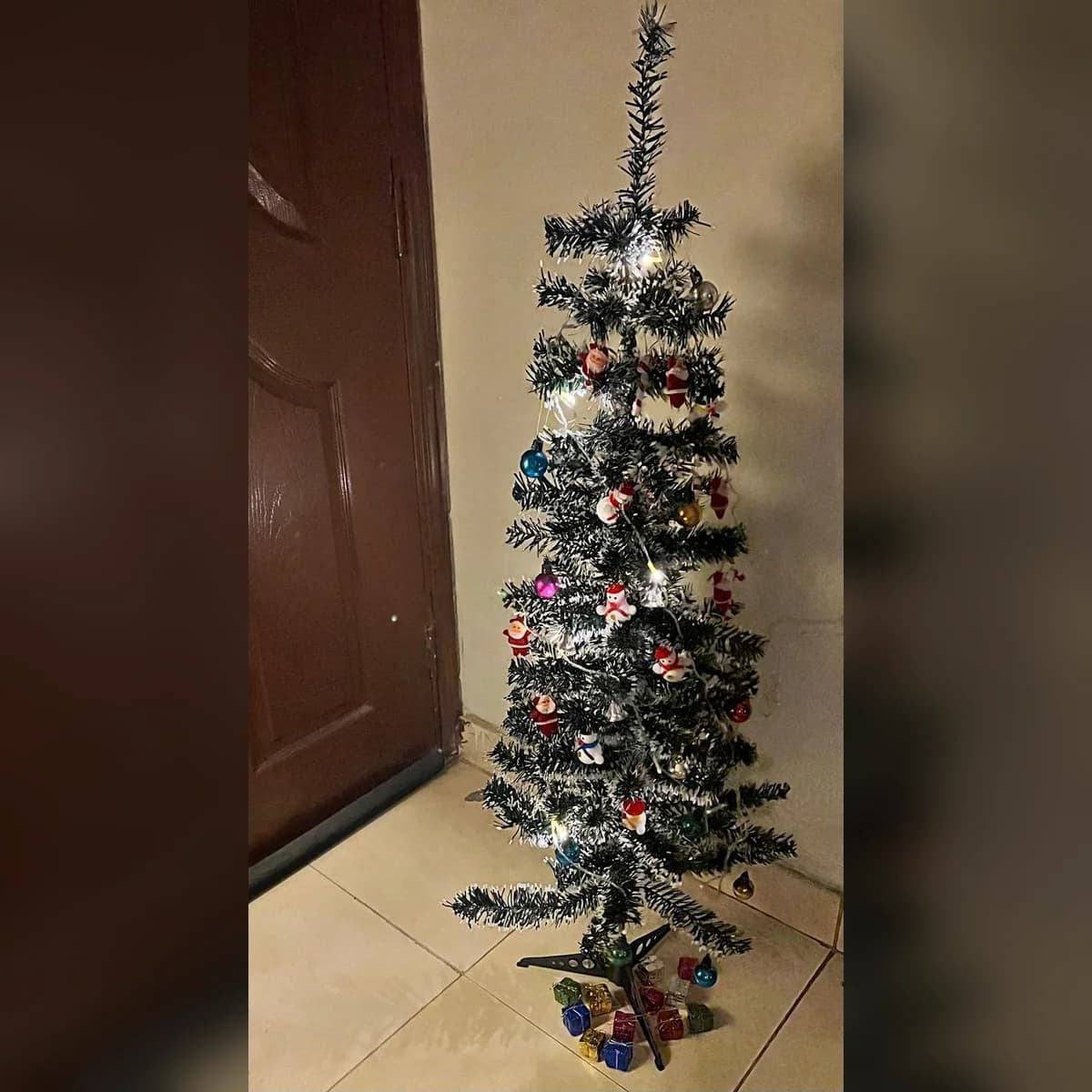 4 ft snow green artificial Christmas tree, set up at a customer's home