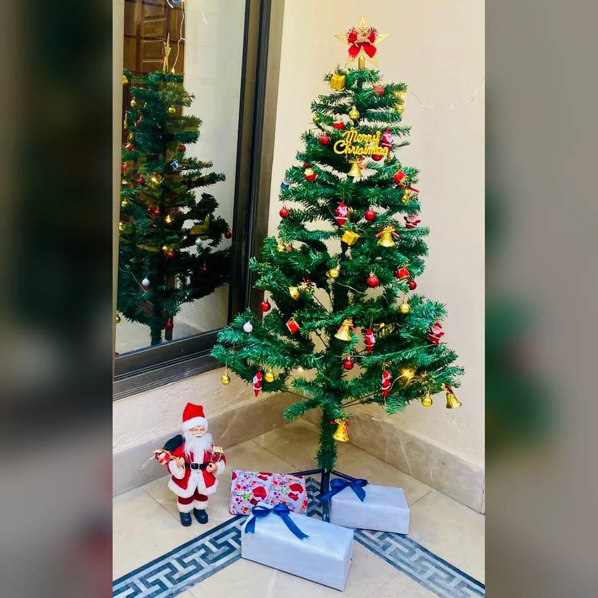 5 ft green artificial Christmas tree, set up at a customer's home