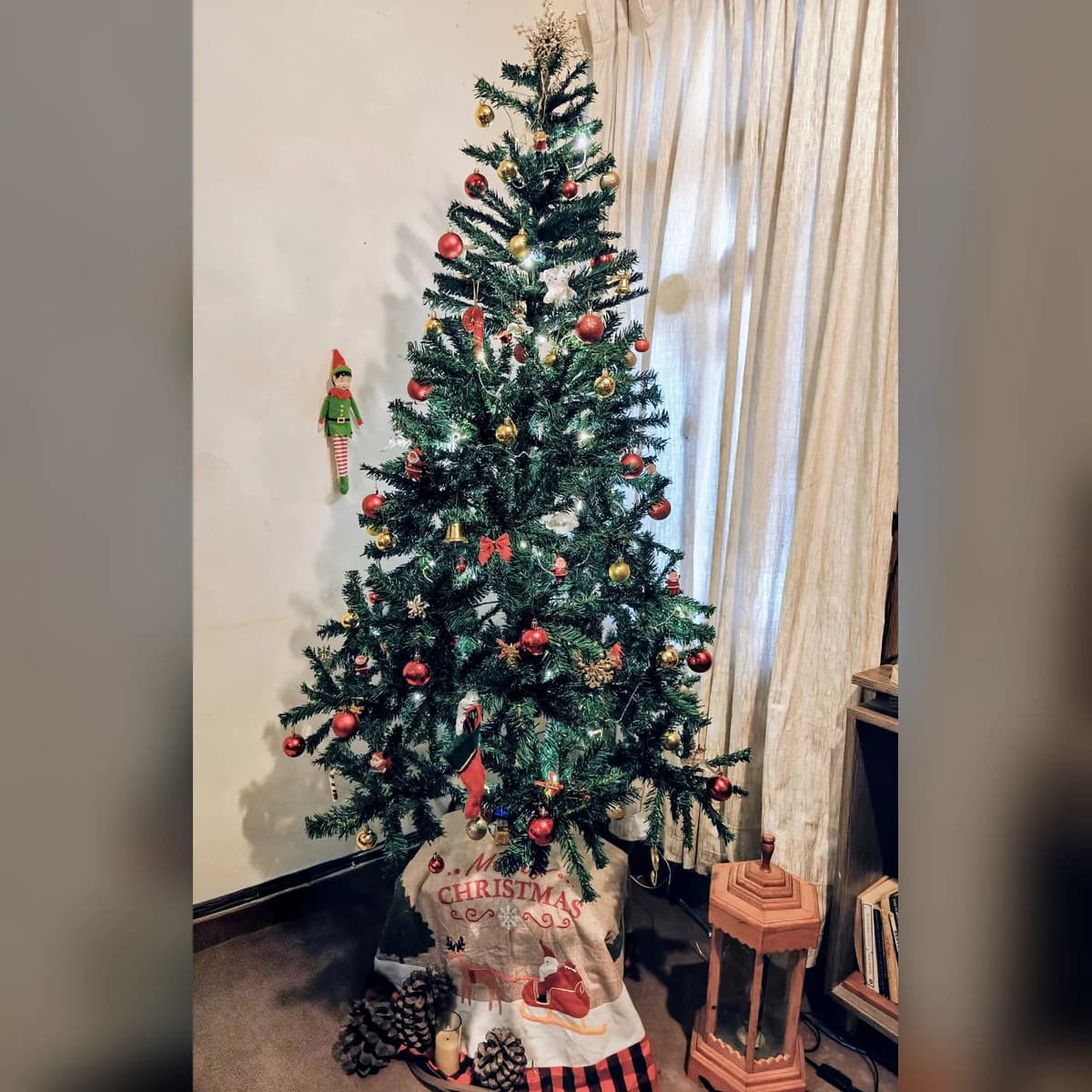 6 ft green artificial Christmas tree, set up at a customer's home