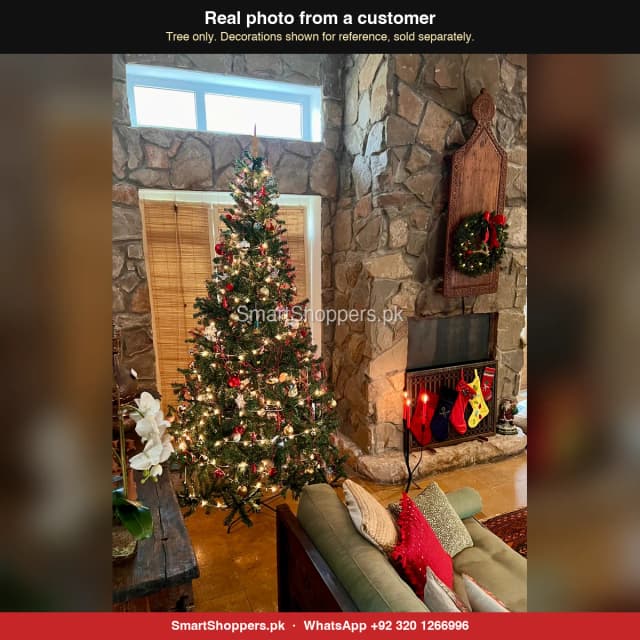 9 ft green Christmas tree beside a fireplace with stockings