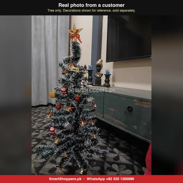 3 ft Snow Green Christmas tree with a star, Santas and red balls beside a TV cabinet