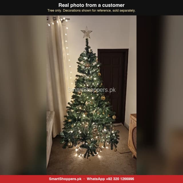 Customer's 7 ft green Christmas tree decorated with gold balls and fairy lights