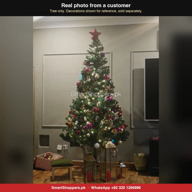 8 ft green Christmas tree with a red star, pink balls and lanterns