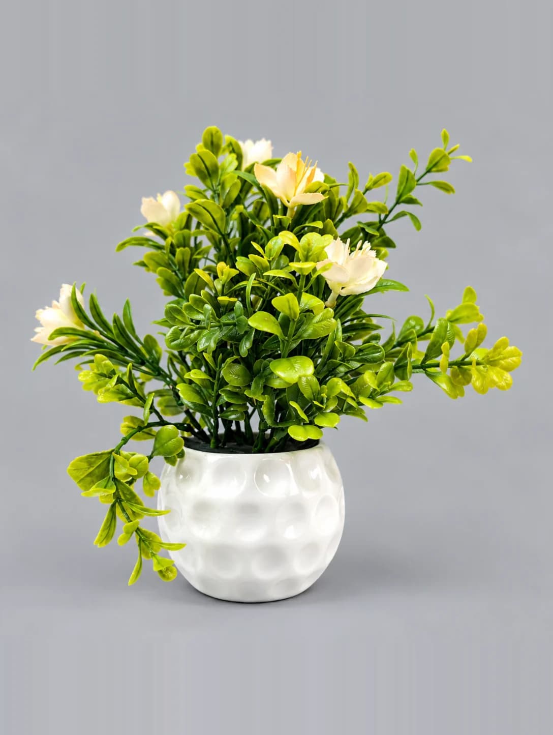 Artificial Cream and Green Flower Plant in White Dimpled Round Pot