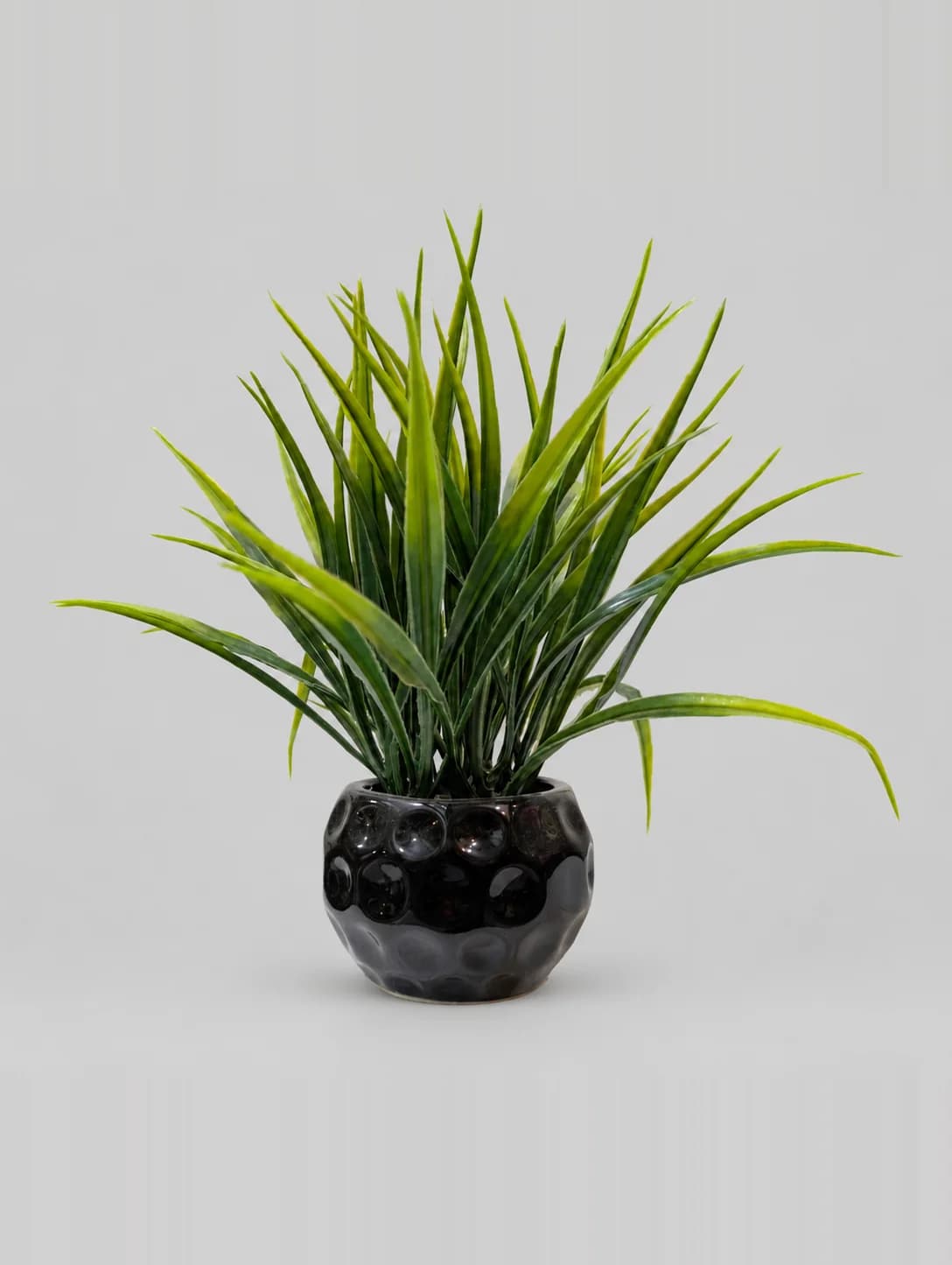 Artificial Green Grass Plant in Black Dimpled Round Pot