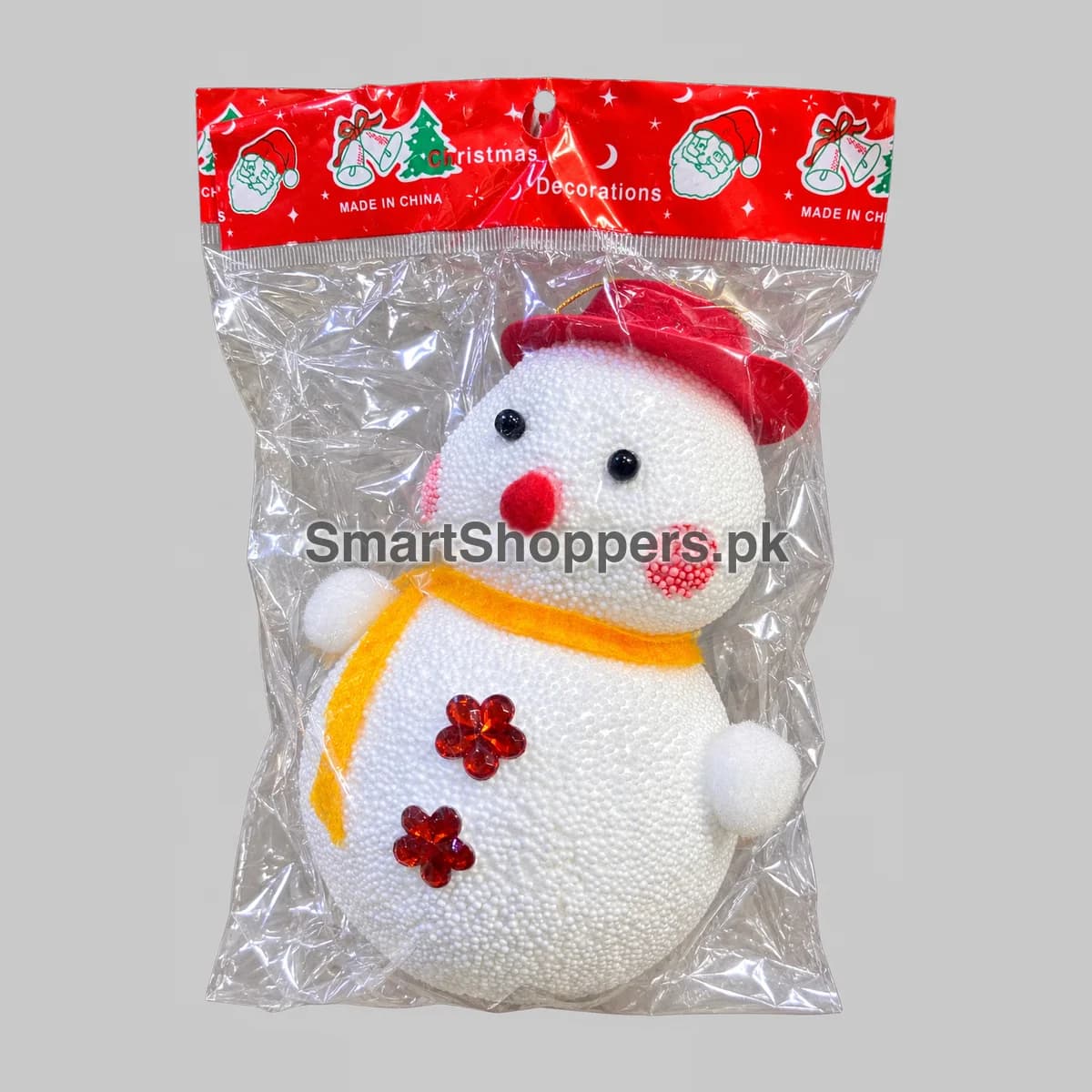 Large white thermocol snowman ornament with a red hat and a scarf, in its pack