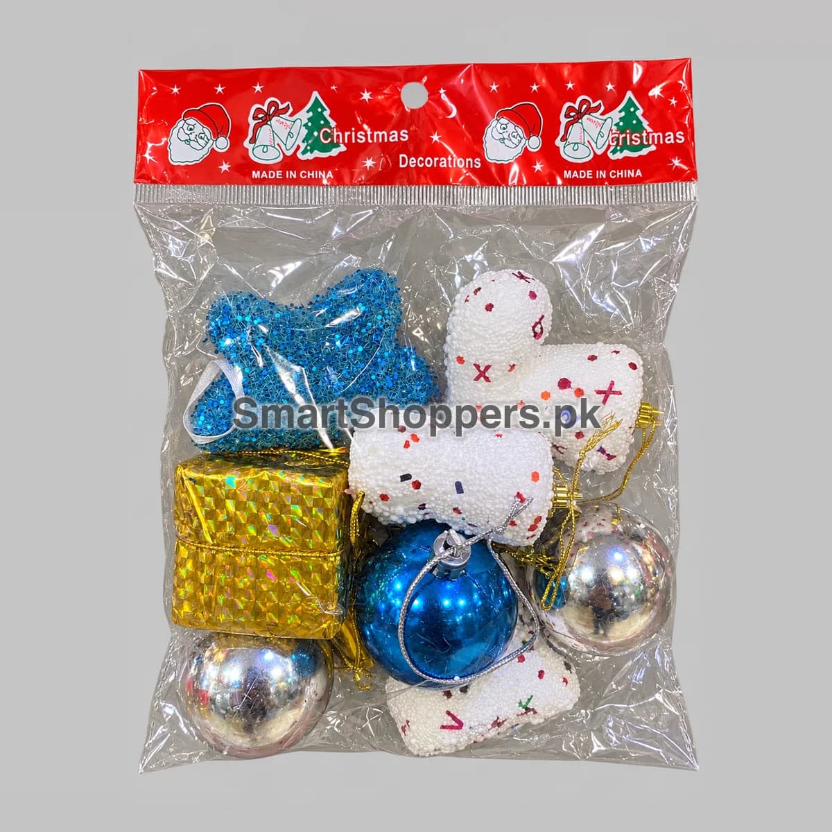 Mixed Christmas ornament pack in a clear hanging bag: blue ball, silver balls, blue sequin star, gold gift box and white speckled pieces