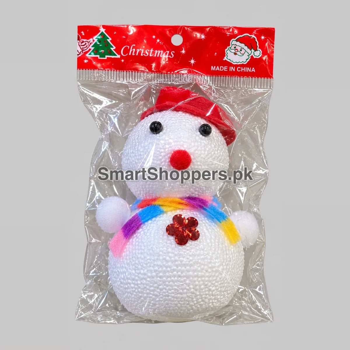 Small white thermocol snowman with a red hat and a rainbow scarf, in its pack