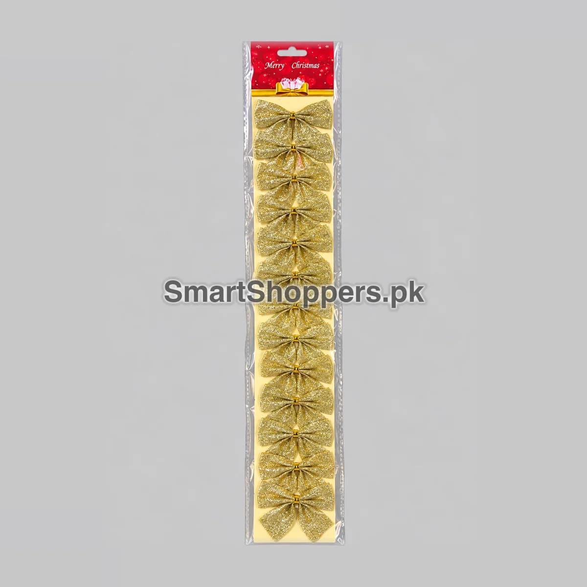 Strip of 12 small gold glitter bows on a card with a Merry Christmas header, in its bag
